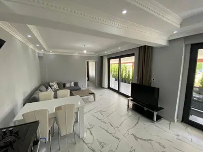 a living room with a white table and a couch at Ege Naz 1 in Marmara