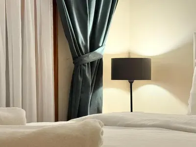 a bedroom with a bed with a curtain and a lamp at Manzara Ödüllü Büyük Havuzlu Premium Villa in Dibektaş