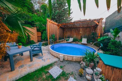 a backyard with a hot tub and a table and chairs at Sapanca Villa Şen in Sapanca