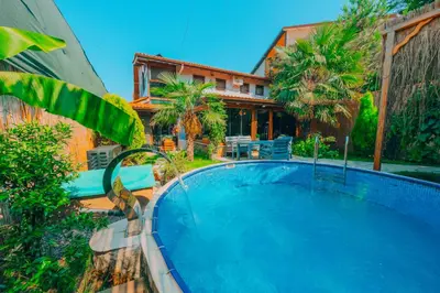 a large swimming pool in front of a house at Sapanca Villa Şen in Sapanca