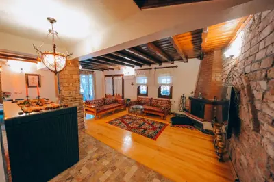 a large living room with a stone wall at Sapanca Villa Şen in Sapanca