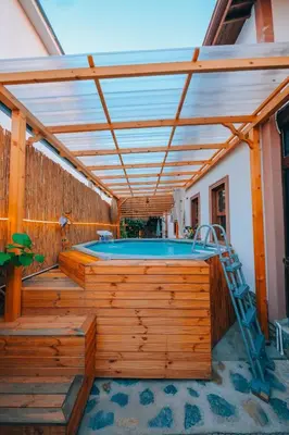 a hot tub on a wooden deck with a pergola at Sapanca Villa Şen 2 in Sapanca