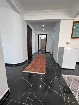 an empty hallway with a rug on the floor and a kitchen at beyzade palace in Istanbul