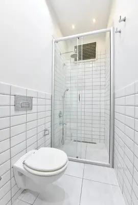 a white bathroom with a shower and a toilet at Charming Flat Retro Design AC Galata in Istanbul