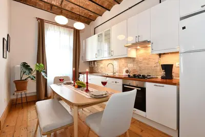 a kitchen with a wooden table and white cabinets at Charming Flat Retro Design AC Galata in Istanbul
