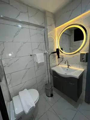 a bathroom with a sink and a toilet and a mirror at Sara Suit in Istanbul