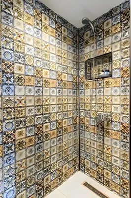 a bathroom with a mosaic tile wall at The Lumina Hotel in Istanbul