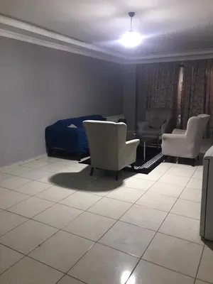 a living room with two chairs and a bed at Rosse Hotel in Kırac