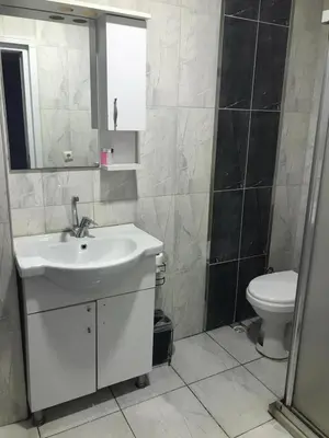 a bathroom with a sink and a toilet at Rosse Hotel in Kırac