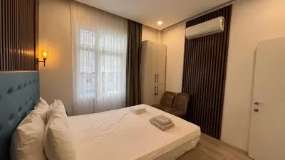 a hotel room with a bed and a window at Taksim Square Luxury 4BR Next to Hotels Perfect for Families & Groups in Istanbul