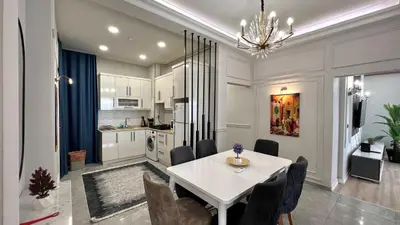 a kitchen and dining room with a white table and chairs at Taksim Square Luxury 4BR Next to Hotels Perfect for Families & Groups in Istanbul