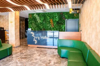 a lobby of a hotel with a green couch at ivy Hotel Spa in Yalova