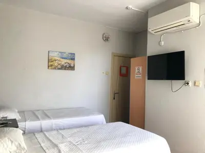 a hospital room with two beds and a flat screen tv at GOLD SARAY PANSİYOn in Saray