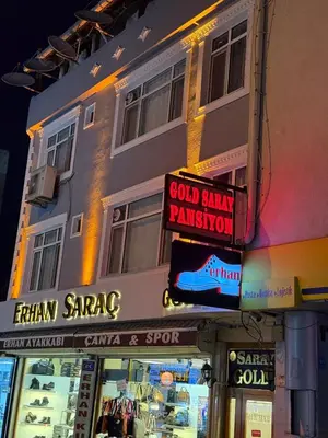 a building with signs on the side of it at GOLD SARAY PANSİYOn in Saray