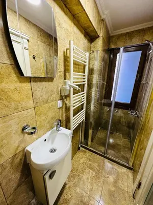 a bathroom with a sink and a shower at LA MAİSON FAMILY Hotel in Istanbul