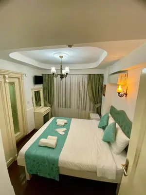 a bedroom with a large bed with towels on it at LA MAİSON FAMILY Hotel in Istanbul