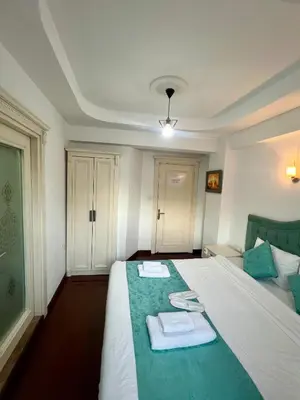 a bedroom with a bed with two towels on it at LA MAİSON FAMILY Hotel in Istanbul