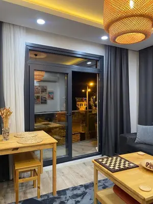 a living room with a table and a large window at Apartment - Little Hagia Sophia in Istanbul