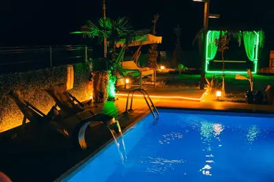 a swimming pool at night with a water slide at MedaSuite Stone House with Detached Pool in Kandıra
