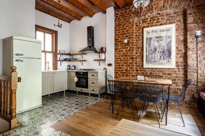 a kitchen with a table and a brick wall at Chic 2BR Retreat House - Heart of Cihangir! #394 in Istanbul