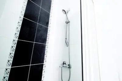 a shower in a bathroom with a black and white at Chic Apartment Walk to Maçka Park Nişantaşı in Istanbul