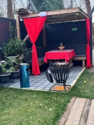 a table with a red curtain and a cross on it at Sapancasadembungalov in Sapanca