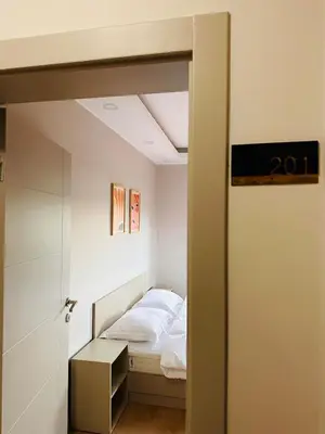 a small bedroom with a bed and a mirror at Villa Casa Bianca in Sapanca