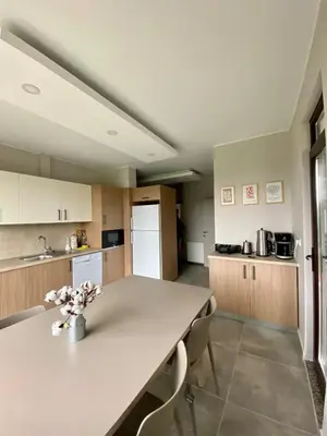 a large kitchen with a table and chairs in it at Villa Casa Bianca in Sapanca