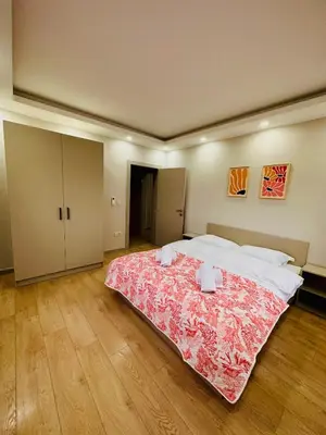 a bedroom with a large bed with a red blanket at Villa Casa Bianca in Sapanca