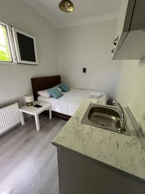 a kitchen with a sink and a bed in a room at Şişli Suites - Room23 in Istanbul