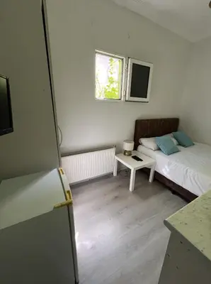 a small room with two beds and a table at Şişli Suites - Room23 in Istanbul