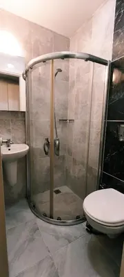 a bathroom with a shower and a toilet and a sink at Şişli Suites - Room23 in Istanbul