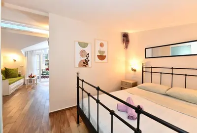a bedroom with a bed and a living room at Private Terrace AC Bright Flat Galata in Istanbul