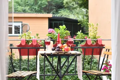 a table with fruit and wine glasses on a balcony at Private Terrace AC Bright Flat Galata in Istanbul