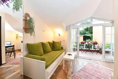 a living room with a green couch and a balcony at Private Terrace AC Bright Flat Galata in Istanbul