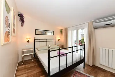 a small bedroom with a bed and a window at Private Terrace AC Bright Flat Galata in Istanbul