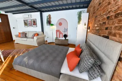 a bedroom with a bed and a brick wall at Cute Retro Home Balcony AC Galata in Istanbul