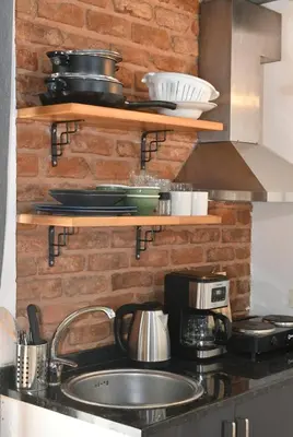 a kitchen with a sink and a brick wall at Cute Retro Home Balcony AC Galata in Istanbul