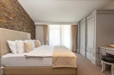 a bedroom with a large bed and a brick wall at Galata Fil Hotel in Istanbul