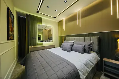 a bedroom with a large bed and a mirror at Taksim Square 1 plus 1 fully equipped air conditioned luxury apartment in Istanbul