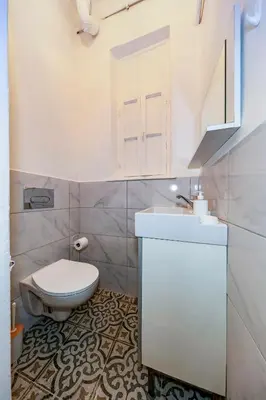 a white bathroom with a toilet and a sink at The Heaven on Heritage Street in Istanbul