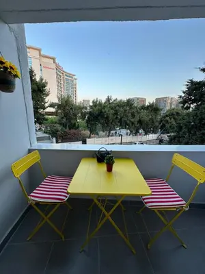a yellow table and two chairs on a balcony at Heart of the City - Zey in Güzelce