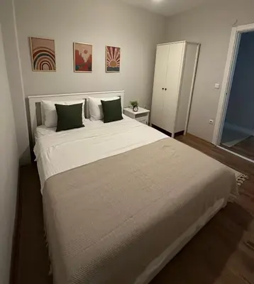 a bedroom with a large white bed with two pillows at Heart of the City - Zey in Güzelce