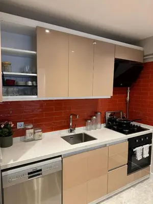 a kitchen with white cabinets and a sink at Heart of the City - Zey in Güzelce