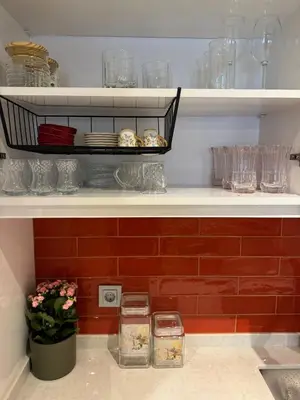 a shelf with glasses and a basket of food at Heart of the City - Zey in Güzelce
