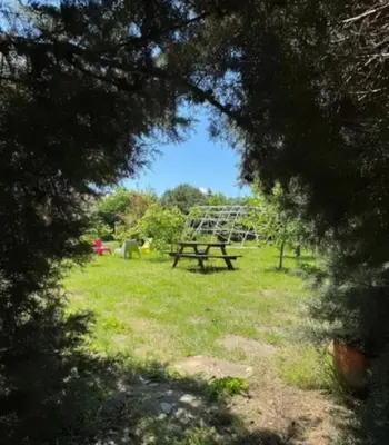 a park with a picnic table and a swing set at Meşeliev Pansiyon in Demirköy