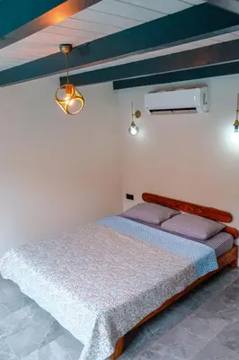 a bedroom with a bed and two lights at MoonSA Boutique Villas in Sapanca