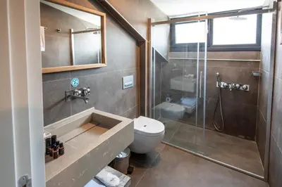a bathroom with a toilet and a glass shower at Hotel Bosfora in Istanbul