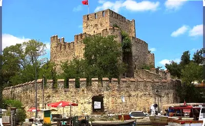 a large castle with a flag on top of it at An Istanbul tale, an Istanbul dream, garden house in Istanbul