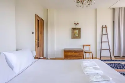 a bedroom with a white bed and a ladder at Spacious 4BR Home - Stunning Bosphorus Views! #390 in Istanbul